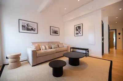 a living room with a couch and a table at Seaview with Terrace in Cannes in Cannes
