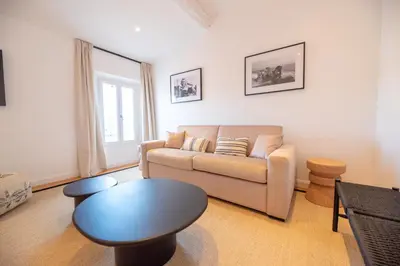 a living room with a couch and a table at Seaview with Terrace in Cannes in Cannes