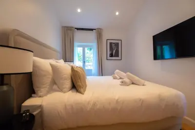 a bedroom with a white bed with a teddy bear on it at Seaview with Terrace in Cannes in Cannes