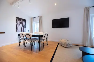 a dining room with a black table and chairs at Seaview with Terrace in Cannes in Cannes
