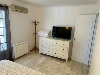 a bedroom with a dresser with a tv on it at Maison provençale in Le Cannet