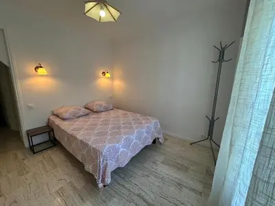 a bedroom with a bed with two pillows on it at Maison provençale in Le Cannet