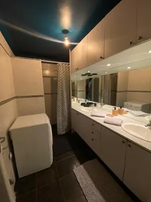 a bathroom with two sinks and a large mirror at Maison provençale in Le Cannet