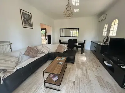 a living room with a couch and a piano at Maison provençale in Le Cannet