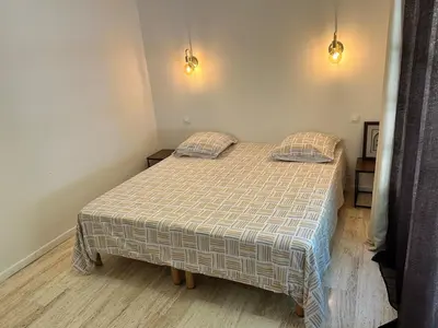 a bed in a bedroom with two pillows on it at Maison provençale in Le Cannet