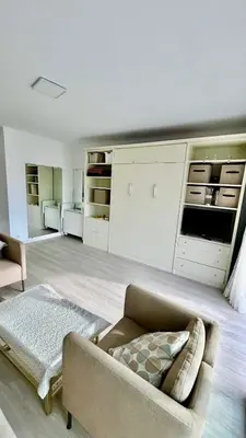 a living room with a couch and a kitchen at Nid douillet près de la Croisette in Cannes