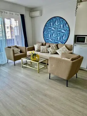a living room with a couch and two chairs at Nid douillet près de la Croisette in Cannes