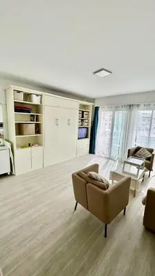 a living room with a couch and a chair at Nid douillet près de la Croisette in Cannes