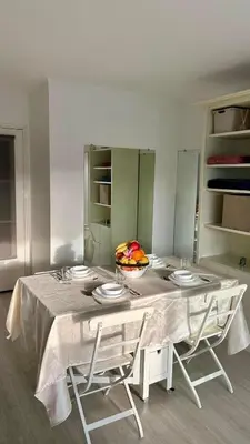 a table with four chairs and a bowl of fruit on it at Nid douillet près de la Croisette in Cannes