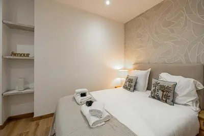 a bedroom with a bed with a camera on it at Magnificent apartment - AC- 2BR- 4P - Cannes in Cannes