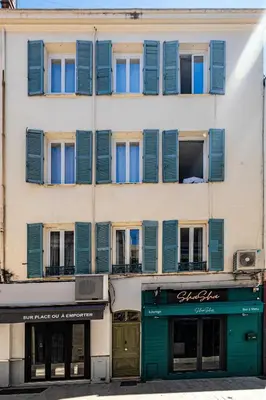 a tall building with blue shuttered windows on it at Magnificent apartment - AC- 2BR- 4P - Cannes in Cannes