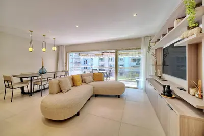 a living room with a couch and a dining room at REF 1442 - Cannes Center - Apartment for rent in Cannes