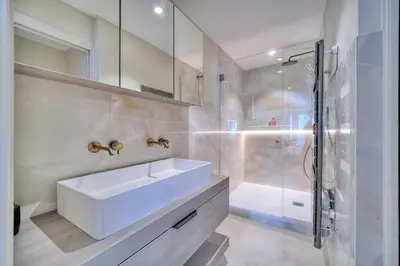 a white bathroom with a sink and a shower at REF 1442 - Cannes Center - Apartment for rent in Cannes