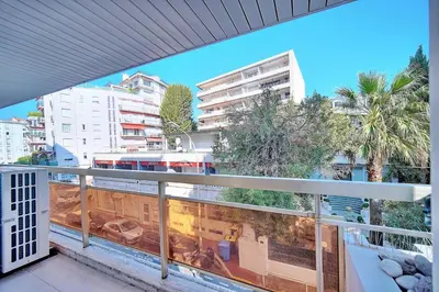 a balcony with a view of a train on the tracks at REF 1442 - Cannes Center - Apartment for rent in Cannes