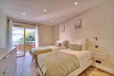 two beds in a room with a window at REF 1442 - Cannes Center - Apartment for rent in Cannes