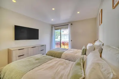 two beds in a room with a tv on the wall at REF 1442 - Cannes Center - Apartment for rent in Cannes
