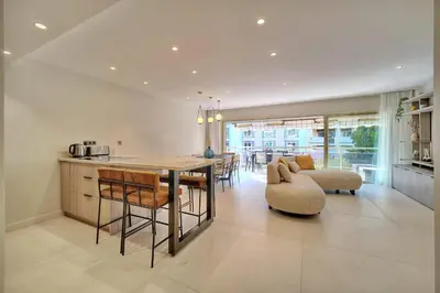 a kitchen and living room with a table and chairs at REF 1442 - Cannes Center - Apartment for rent in Cannes