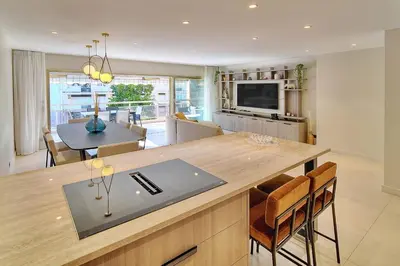 a kitchen and living room with a table and chairs at REF 1442 - Cannes Center - Apartment for rent in Cannes