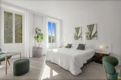 a white bedroom with a bed and two chairs at REF 783 - Cannes Croisette - Apartment for rent in Cannes