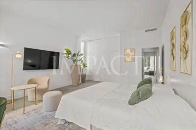 a white bedroom with a bed and a tv at REF 783 - Cannes Croisette - Apartment for rent in Cannes