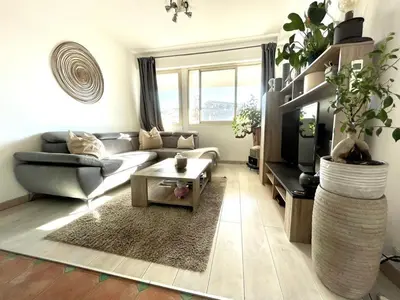 a living room with a couch and a table at Bel appartement central 2 chambres in Cannes