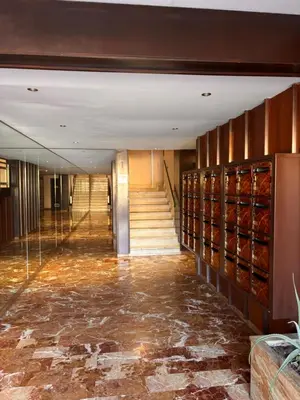 a hallway with a marble floor and stairs in a building at Bel appartement central 2 chambres in Cannes