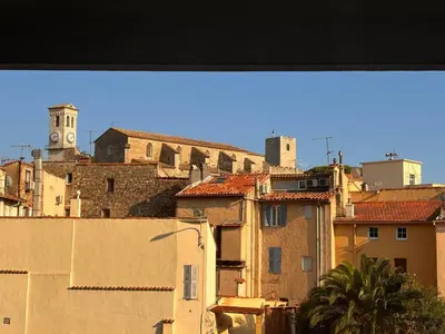 a view of a city with buildings and a clock tower at Bel appartement central 2 chambres in Cannes