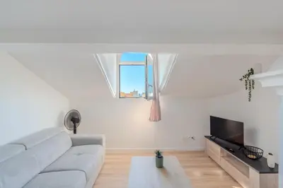 a white living room with a couch and a window at Cozy T2 Centre Cannes proche Suquet in Cannes