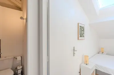 a bathroom with a toilet and a window at Cozy T2 Centre Cannes proche Suquet in Cannes