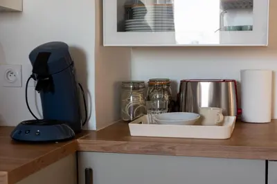 a kitchen counter top with a coffee maker and a coffee pot at Cozy T2 Centre Cannes proche Suquet in Cannes