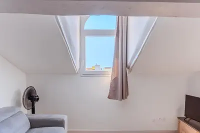 a window in a living room with a couch at Cozy T2 Centre Cannes proche Suquet in Cannes