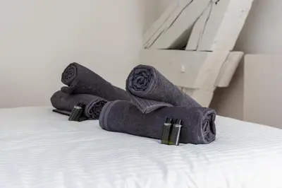 a pile of towels sitting on a bed at Cozy T2 Centre Cannes proche Suquet in Cannes