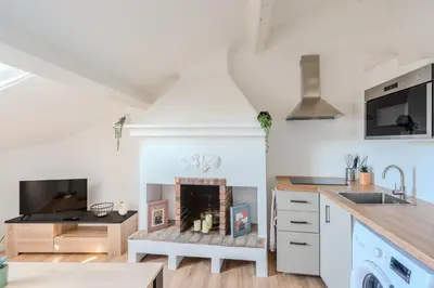 a kitchen with a fireplace in the middle at Cozy T2 Centre Cannes proche Suquet in Cannes