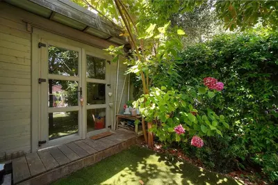 a porch of a house with a window and flowers at FRGK Villa Bohème Chic Private Pool UltraFast WiFi in Le Cannet