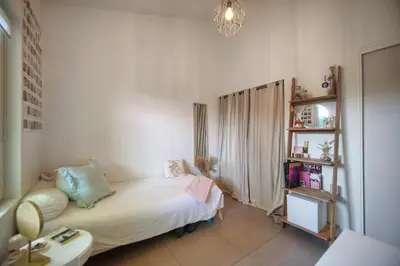 a small bedroom with a bed and a book shelf at FRGK Villa Bohème Chic Private Pool UltraFast WiFi in Le Cannet