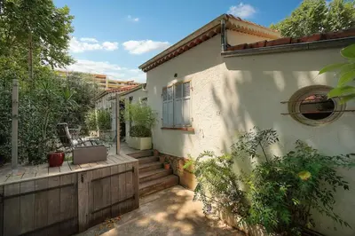 a house with a porch and stairs in front of it at FRGK Villa Bohème Chic Private Pool UltraFast WiFi in Le Cannet