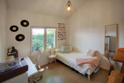 a bedroom with a bed and a window and a mirror at FRGK Villa Bohème Chic Private Pool UltraFast WiFi in Le Cannet