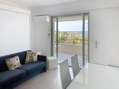 a living room with a couch and a view of the ocean at Bright one bedroom apartment on La Croisette in Cannes