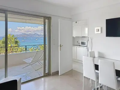 a kitchen and dining room with a view of the ocean at Bright one bedroom apartment on La Croisette in Cannes