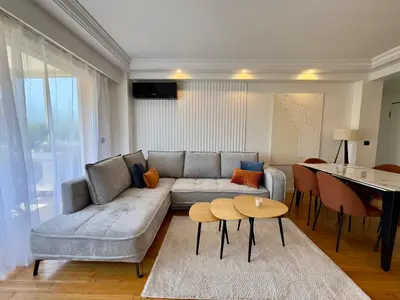 a living room with a couch and a table at Cannes Azur - SCLS Locations in Cannes