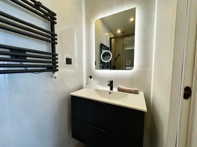 a bathroom with a sink and a mirror at Cannes Azur - SCLS Locations in Cannes