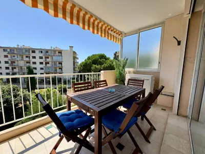a dining table and chairs on a balcony with a view at Cannes Azur - SCLS Locations in Cannes