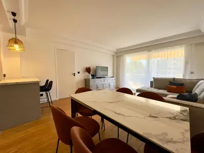 a living room with a table and chairs and a couch at Cannes Azur - SCLS Locations in Cannes