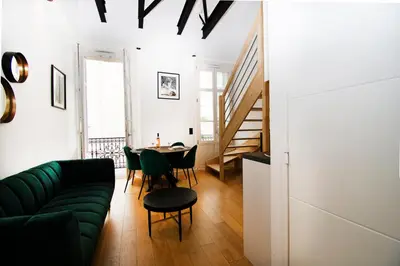 a living room with a green couch and a table at L'Ecrin Festivalier Standing Presta in Cannes