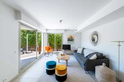 a living room with a couch and a table at 1-Br Garden Apartment with Pool Peaceful Private Parking in Cannes