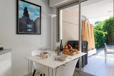 a kitchen with a table with a basket of fruit on it at 1-Br Garden Apartment with Pool Peaceful Private Parking in Cannes