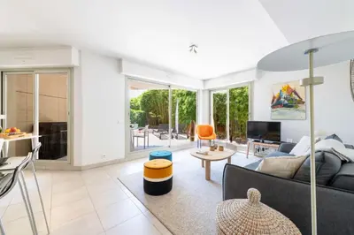 a living room with a couch and a table at 1-Br Garden Apartment with Pool Peaceful Private Parking in Cannes
