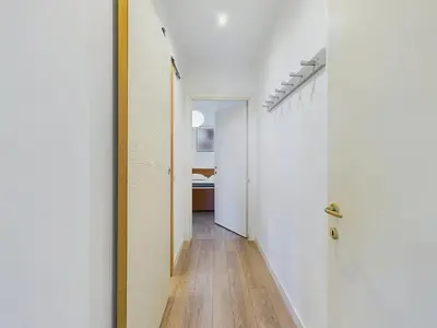 a hallway with white walls and a wooden floor at Centre Cannes Serbes in Cannes