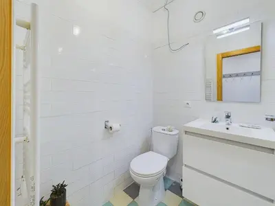 a white bathroom with a toilet and a sink at Centre Cannes Serbes in Cannes