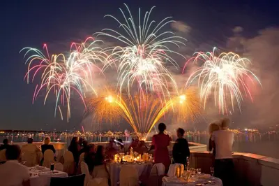 a group of people sitting at tables watching fireworks at Sea view, Luminous, Terrace, Garage, AC, Design in Cannes